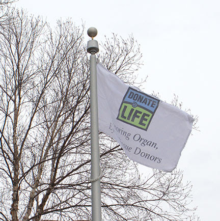 Donate Life Honoring Organ, Eye, and Tissue Donors flag flies on flag pole
