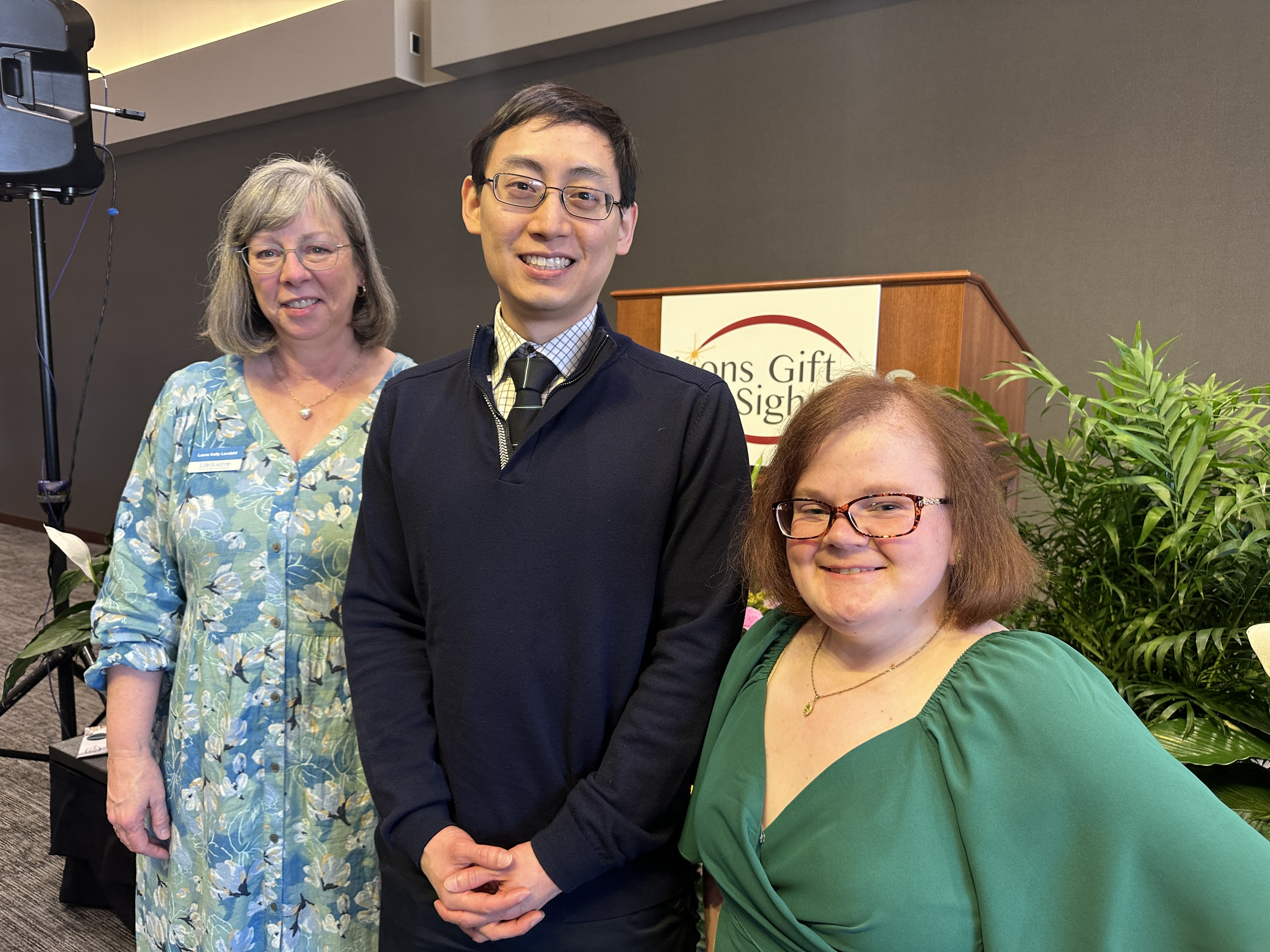 Photo. Donor Recognition Program guest speakers, left to right, Laura Kelly-Lovdahl (donor daughter), Dr. Joshua Hou (surgeon and scientist), and Jessica Moore (corneal recipient).