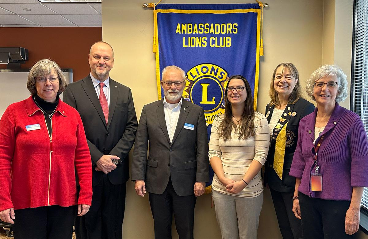 Photo of new Lions club members along with District Governor Jennifer.